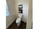 The toilet area features built-in shelving for convenient towel storage and space-saving design at 128 W Walnut St, Lebanon, IN 46052