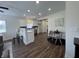 Bright kitchen with white cabinets, stainless appliances, an island and wood-look floors at 128 W Walnut St, Lebanon, IN 46052