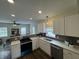 Bright kitchen with white cabinets, stainless appliances, and view to living space, perfect for cooking at 128 W Walnut St, Lebanon, IN 46052