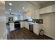 Modern kitchen featuring white cabinets, stainless steel appliances and a view of the living space at 128 W Walnut St, Lebanon, IN 46052