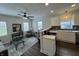 Sunlit open-concept kitchen with granite counters flows seamlessly into the living area at 128 W Walnut St, Lebanon, IN 46052