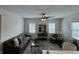 Sunlit living room features neutral paint, grey sofas, a ceiling fan and stylish decor with modern finishes at 128 W Walnut St, Lebanon, IN 46052