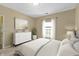 Bright bedroom with natural light, clean colored dresser, carpet, and a comfortable bed at 12820 University Cres # 3D, Carmel, IN 46032