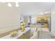 Open concept dining area seamlessly flows into a well-equipped kitchen and living space at 12820 University Cres # 3D, Carmel, IN 46032