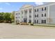 View of the building's front exterior with meticulously kept landscaping and a clear blue sky at 12820 University Cres # 3D, Carmel, IN 46032