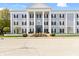 Elegant building with stately columns and manicured landscaping offers a refined living experience at 12820 University Cres # 3D, Carmel, IN 46032