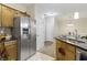 Bright kitchen with stainless steel refrigerator, granite countertops, and breakfast nook with natural light at 12820 University Cres # 3D, Carmel, IN 46032