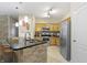 Modern kitchen boasts stainless steel appliances, granite countertops, and ample cabinet space at 12820 University Cres # 3D, Carmel, IN 46032