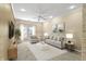Cozy living room with stone accent wall, neutral furniture, and lots of natural light at 12820 University Cres # 3D, Carmel, IN 46032