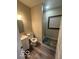 Bright bathroom featuring a shower and vanity, complemented by stylish flooring at 137 S 2Nd Ave, Beech Grove, IN 46107