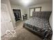 Cozy bedroom with a plush bed, a modern headboard, and an organized closet at 137 S 2Nd Ave, Beech Grove, IN 46107