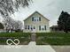 Charming two-story home with a well-manicured front yard, set back from the street at 137 S 2Nd Ave, Beech Grove, IN 46107