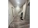 Inviting hallway with durable gray floors, neutral walls, and a view of the staircase at 137 S 2Nd Ave, Beech Grove, IN 46107