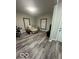 Cozy living room featuring modern gray floors, neutral walls, and two large windows at 137 S 2Nd Ave, Beech Grove, IN 46107