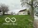 A wide shot of the house and yard from the street at 137 S 2Nd Ave, Beech Grove, IN 46107