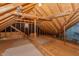 Unfinished attic space with wooden beams, insulation, and potential for storage or finishing at 13797 Mill Stream Ct, Carmel, IN 46032