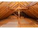 Unfinished attic space showcasing wooden beams and ample potential for customization and storage at 13797 Mill Stream Ct, Carmel, IN 46032
