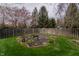 Large backyard with a well-maintained lawn, mature trees, and a charming garden area at 13797 Mill Stream Ct, Carmel, IN 46032