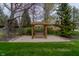 Tranquil backyard featuring a cozy swing under a wooden pergola, perfect for relaxation at 13797 Mill Stream Ct, Carmel, IN 46032