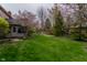 Lush backyard featuring a well-maintained lawn, mature trees, and a sunroom at 13797 Mill Stream Ct, Carmel, IN 46032