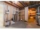 Unfinished basement area with exposed beams, utility components, and potential for customization at 13797 Mill Stream Ct, Carmel, IN 46032