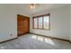 Bright bedroom with a closet, plush carpet, and a window with a tree view at 13797 Mill Stream Ct, Carmel, IN 46032