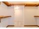 Walk in closet with carpeted floors and built in wood shelving units at 13797 Mill Stream Ct, Carmel, IN 46032