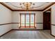 Dining room with elegant chandelier, carpet, and large window at 13797 Mill Stream Ct, Carmel, IN 46032