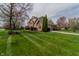 Well-maintained home with lush green lawn, mature trees and an attached garage at 13797 Mill Stream Ct, Carmel, IN 46032