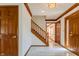 Inviting foyer with marble flooring, wooden staircase, and elegant lighting at 13797 Mill Stream Ct, Carmel, IN 46032