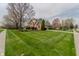 Charming two-story home with brick and siding, mature trees, and well-manicured lawn at 13797 Mill Stream Ct, Carmel, IN 46032