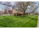 Two-story home with brick and siding, mature trees, and a lush front yard lawn at 13797 Mill Stream Ct, Carmel, IN 46032
