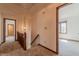 Upstairs hallway featuring a staircase and two open doors at 13797 Mill Stream Ct, Carmel, IN 46032