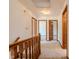 Upstairs hallway with wood trim, carpet, and multiple doors at 13797 Mill Stream Ct, Carmel, IN 46032