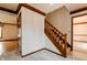 Hallway with light flooring, wood trim, and a carpeted staircase leading to the upper level at 13797 Mill Stream Ct, Carmel, IN 46032