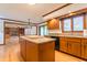 Kitchen with wood cabinets, granite countertops, hardwood floors, and a center island at 13797 Mill Stream Ct, Carmel, IN 46032