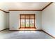 Bright, carpeted living room features chair-rail molding and natural light at 13797 Mill Stream Ct, Carmel, IN 46032
