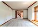 Bright, open living room featuring plush carpeting, wood trim, and large windows with natural light at 13797 Mill Stream Ct, Carmel, IN 46032