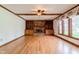 Large living room features a brick fireplace, hardwood floors, built-in cabinets, and natural light at 13797 Mill Stream Ct, Carmel, IN 46032