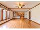 Open living room with hardwood flooring, wood trim, and large windows showcasing natural light at 13797 Mill Stream Ct, Carmel, IN 46032