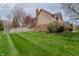 Side view of a two-story home featuring brick, siding, brick chimney, and green grass at 13797 Mill Stream Ct, Carmel, IN 46032