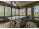 Sunroom with multiple windows, a ceiling fan, and an elegant dining set, offering natural light and views at 13797 Mill Stream Ct, Carmel, IN 46032