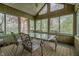 Sunroom with multiple windows, a ceiling fan, and a dining set with views of the backyard at 13797 Mill Stream Ct, Carmel, IN 46032