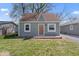 Charming bungalow featuring a light green exterior, a brown roof, and a small, quaint front yard at 1409 S Kiel Ave, Indianapolis, IN 46241
