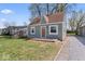 Charming bungalow featuring a light green exterior, a brown roof, and a small, quaint front yard at 1409 S Kiel Ave, Indianapolis, IN 46241