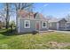 Charming bungalow featuring a light green exterior, a brown roof, and a small, quaint front yard at 1409 S Kiel Ave, Indianapolis, IN 46241
