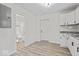 Modern kitchen with stainless steel appliances and sleek countertops, next to a full bathroom at 1409 S Kiel Ave, Indianapolis, IN 46241