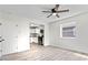Bright living room featuring sleek, light-colored floors, and large windows looking into the kitchen at 1409 S Kiel Ave, Indianapolis, IN 46241