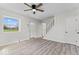 Bright living room featuring sleek, light-colored floors, and large windows at 1409 S Kiel Ave, Indianapolis, IN 46241