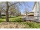 Backyard view featuring a wooden deck and a walking path surrounded by mature trees at 14117 Princewood Dr, Fishers, IN 46037